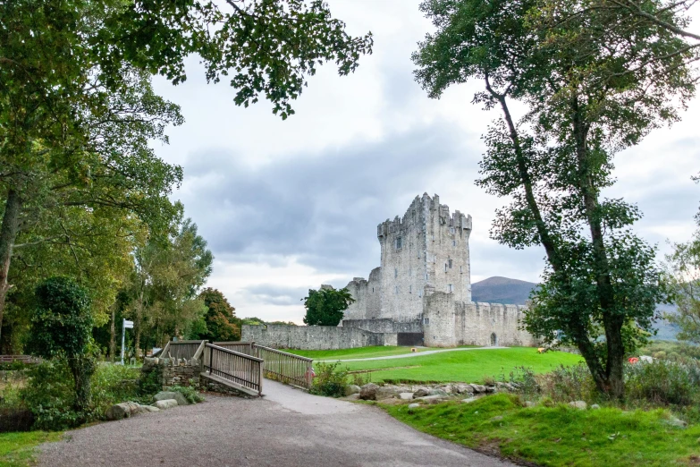a pathway leading to a castle surrounded by trees, inspired by Mór Than, unsplash, arney freyag, exterior view, 2022 photograph, tourist photo