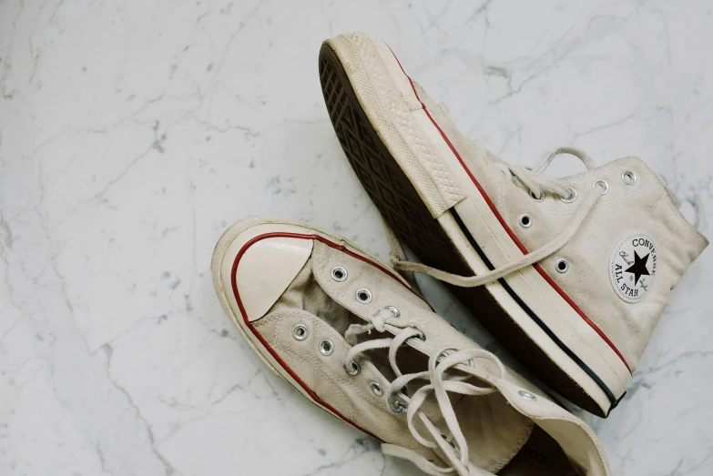 a pair of shoes sitting on top of a marble floor, converse, beige, featured art, marble white complexion