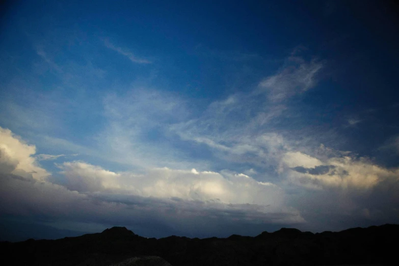 a man riding a snowboard on top of a snow covered slope, unsplash, romanticism, dark mammatus cloud, mojave desert, slide show, evening sky