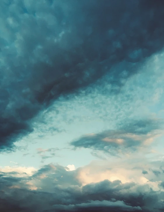 a large body of water under a cloudy sky, an album cover, inspired by Elsa Bleda, unsplash contest winner, aestheticism, ☁🌪🌙👩🏾, evening sky, low - angle shot, trending on vsco