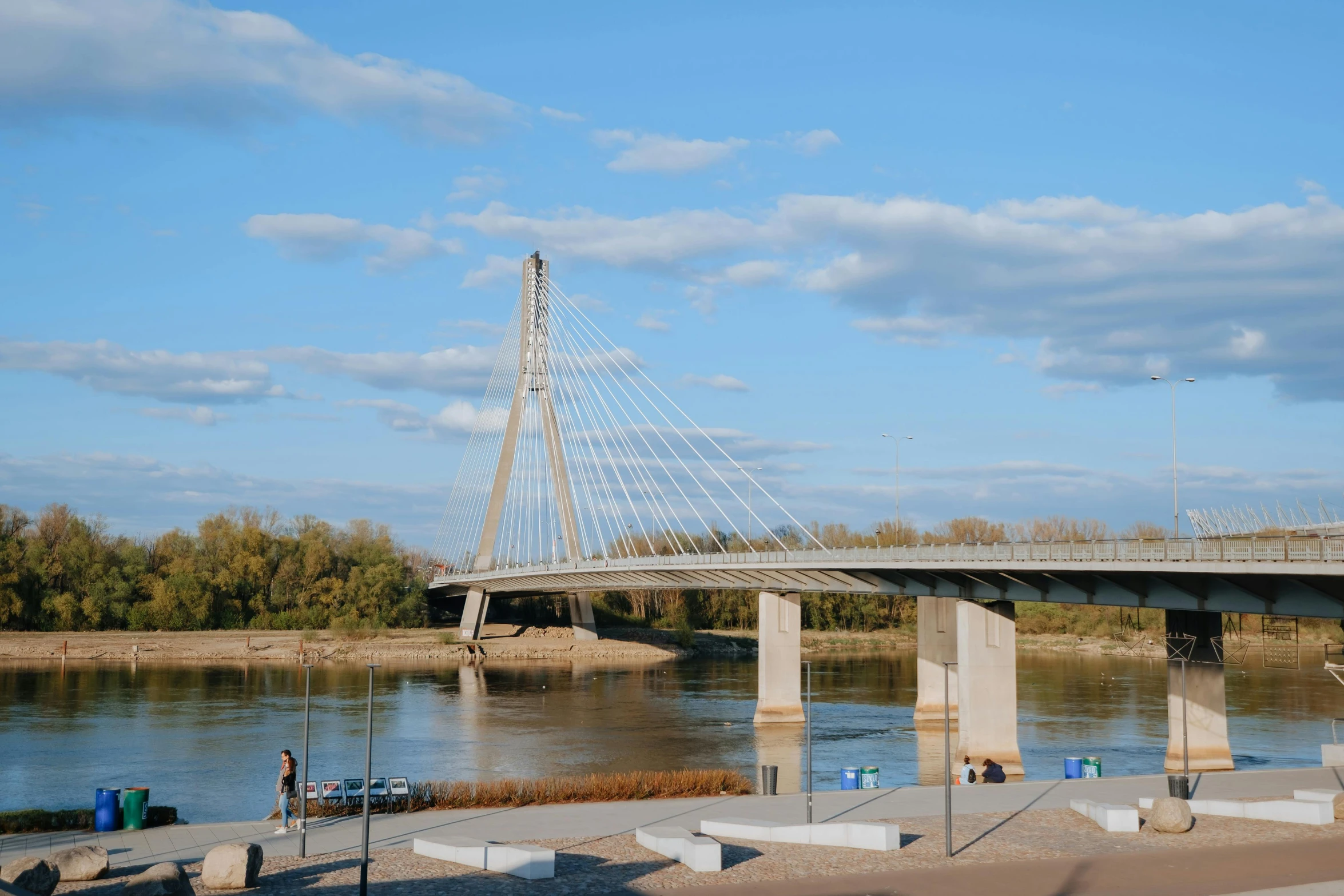 a view of a bridge over a body of water, inspired by Slava Raškaj, pexels contest winner, modernism, rostov city, sunny day time, three views, quebec