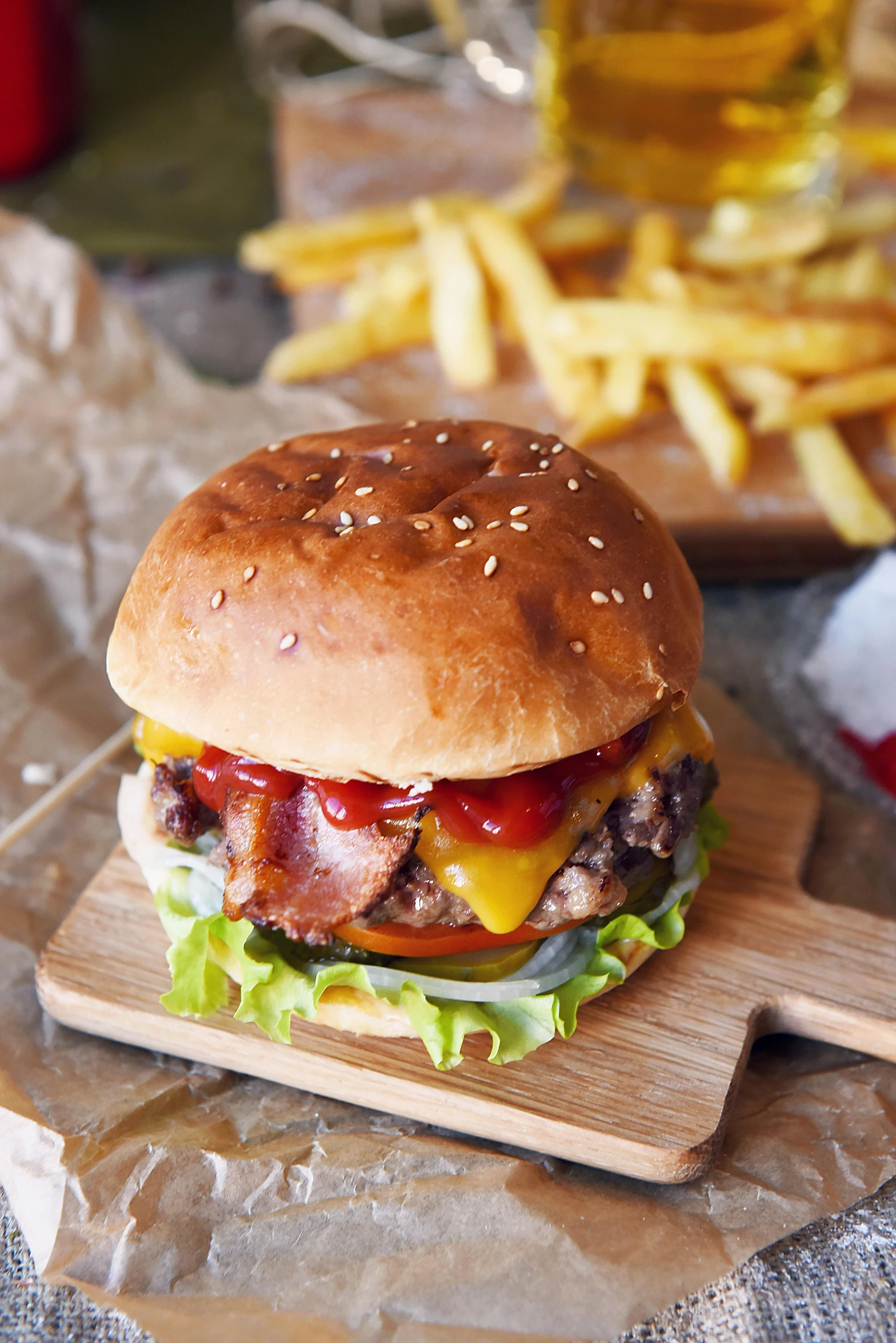 a hamburger sitting on top of a cutting board next to french fries, a picture, hasselblatt, bacon, malaysian, nordic