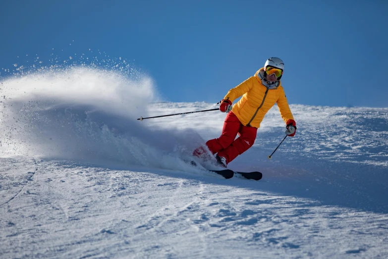 a man riding skis down the side of a snow covered slope, pexels contest winner, sports clothing, avatar image, high resolution, gold