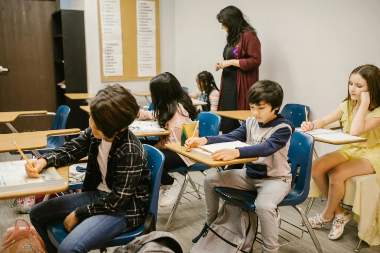 a group of children sitting at desks in a classroom, by Matt Cavotta, pexels contest winner, vancouver school, sitting on a mocha-colored table, ayamin kojima, by greg rutkowski, profile image