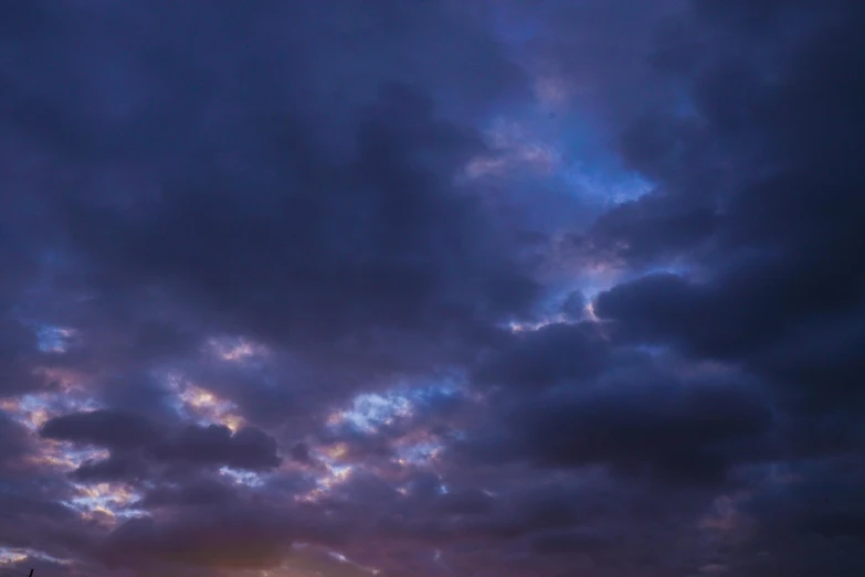 a large body of water under a cloudy sky, a portrait, unsplash, romanticism, predawn, blue and purple, cinematic shot ar 9:16 -n 6 -g, dynamic sky