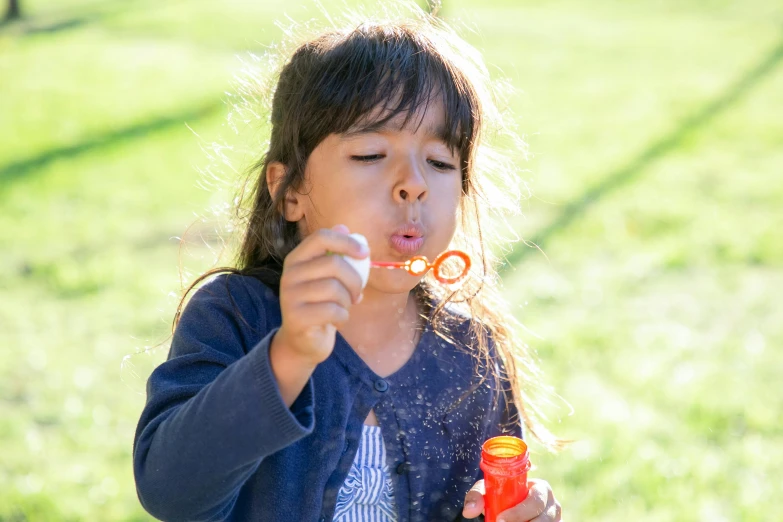 a little girl blowing bubbles in a park, pexels contest winner, blippi, sydney park, barbecuing chewing gum, low detail