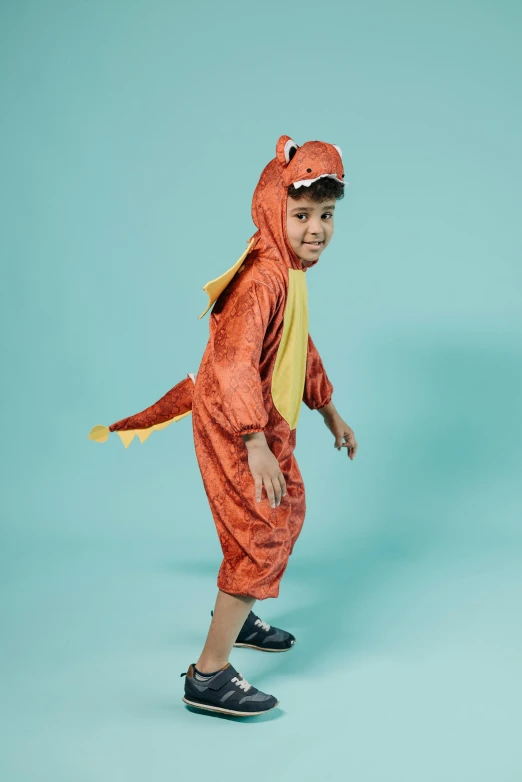 a little boy in a dinosaur costume on a skateboard, an album cover, pexels, orange jumpsuit, red dragon, slide show, studio photo