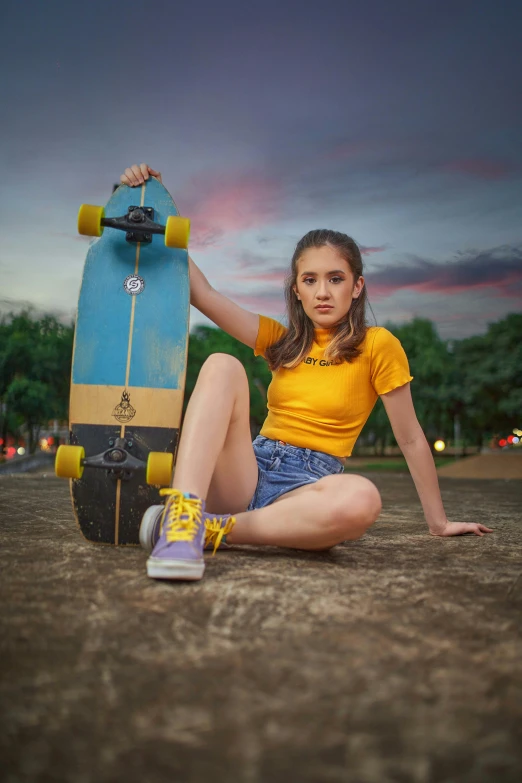 a woman sitting on the ground with a skateboard, by Juan O'Gorman, pexels contest winner, hyperrealism, wearing yellow croptop, avatar image, handsome girl, at twilight