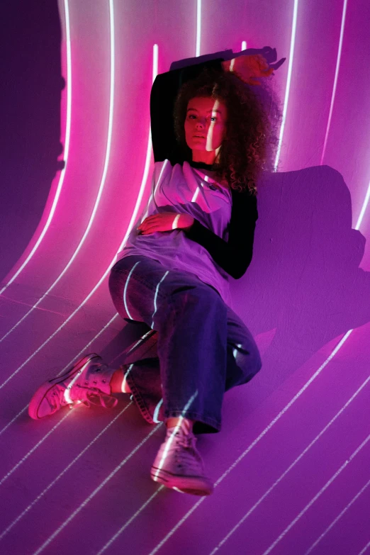 a woman sitting on top of a purple couch, inspired by David LaChapelle, trending on pexels, holography, illuminated neon lines, woman in streetwear, ashteroth, sitting on the floor