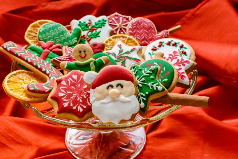 a glass bowl filled with lots of decorated cookies, a portrait, by Maksimilijan Vanka, pexels, vibrant red and green colours, santa, clean and pristine design, avatar image