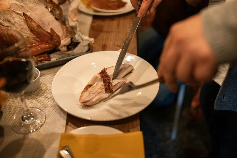 a person cutting a turkey on a white plate, by Niko Henrichon, lachlan bailey, profile image, tourist photo, thumbnail