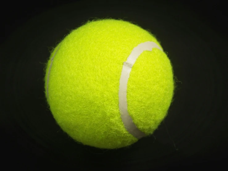 a yellow tennis ball on a black background, pexels, photorealism, ((raytracing)), fan favorite, ultra high resolution, vibrating