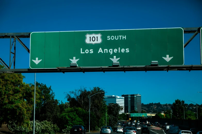 a freeway filled with lots of traffic under a blue sky, a stock photo, by Dan Luvisi, unsplash, graffiti, sign that says 1 0 0, los angelos, discovered photo, ¯_(ツ)_/¯