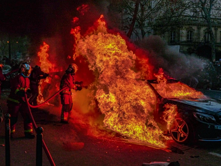 a group of people standing around a burning car, a photo, pexels contest winner, auto-destructive art, miss aniela, fires!! hyperrealistic, demna gvasalia, police officers under heavy fire