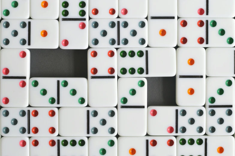 a close up of a number of dominos on a table, by Emma Andijewska, unsplash, generative art, white wall complex, ignant, checkered motiffs, bejeweled