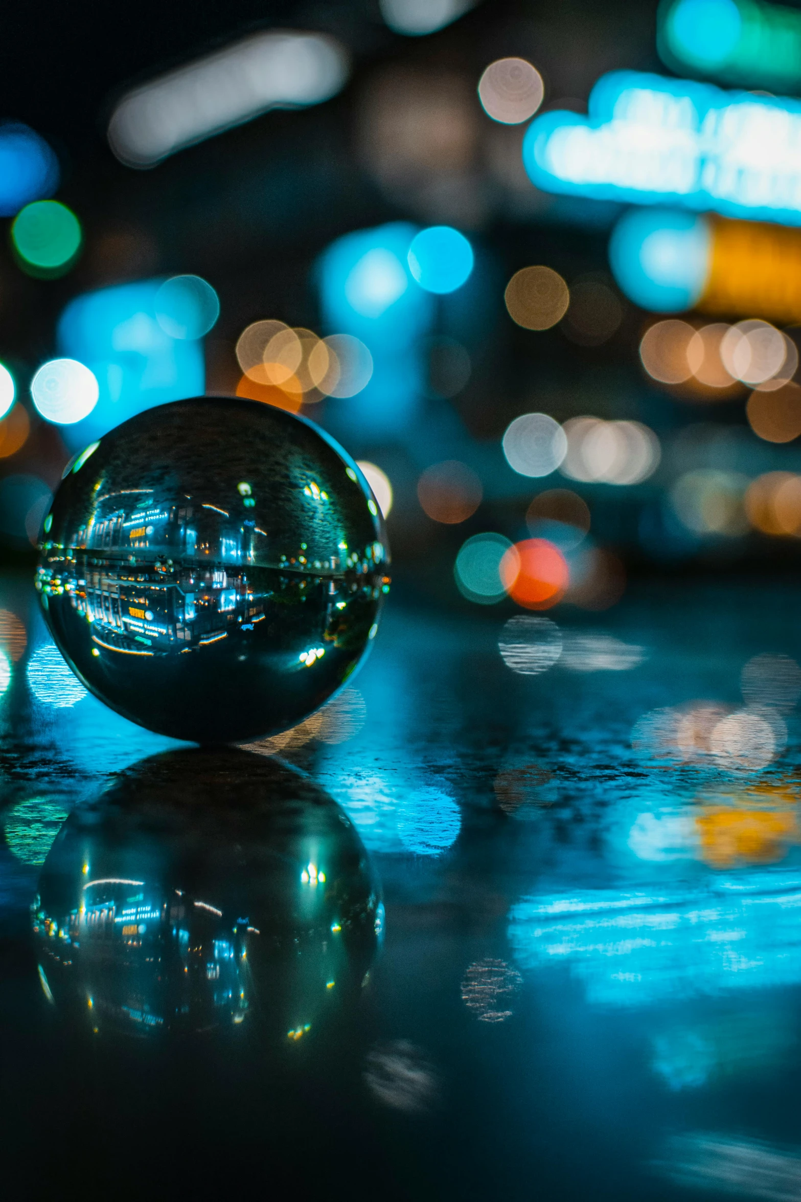 a glass ball sitting on top of a table, a picture, by Chris Rallis, unsplash contest winner, street lights water refraction, city reflections, macro photography 8k, inside a marble