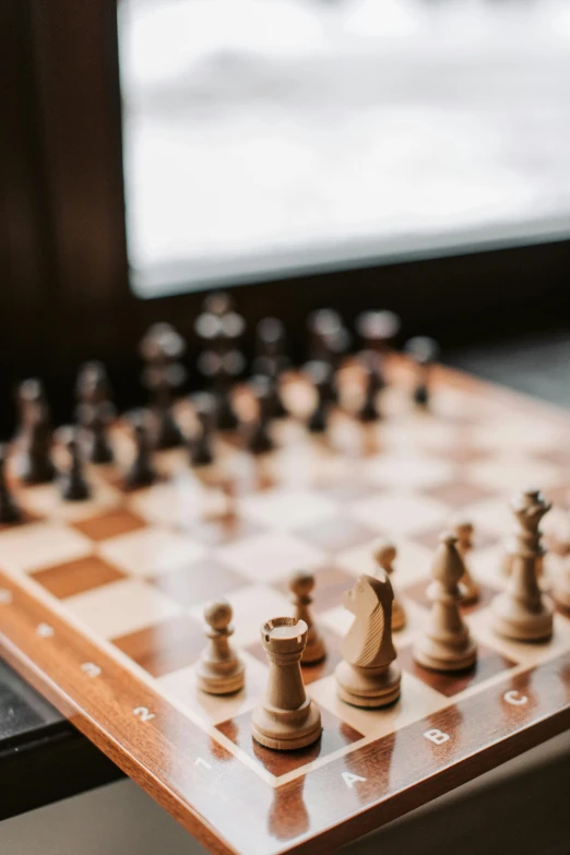 a close up of a chess board on a table, thumbnail, jen atkin, indoor, tournament