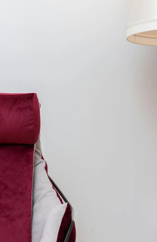 a red blanket sitting on top of a bed next to a lamp, poster art, by Doug Ohlson, trending on pexels, armchair, detail shot, relaxed posture, top angle