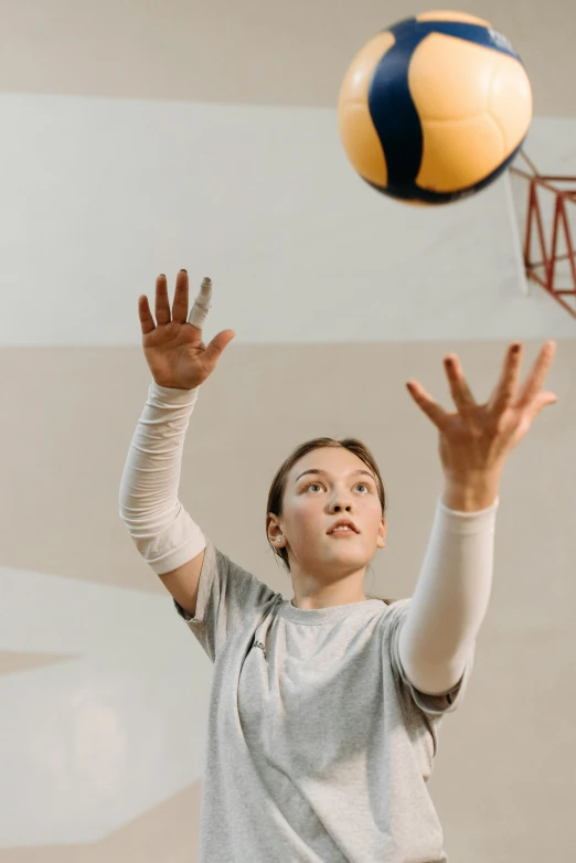 a woman reaching up to hit a volleyball, inspired by Mia Brownell, pexels contest winner, teenage boy, shrugging arms, softplay, working out