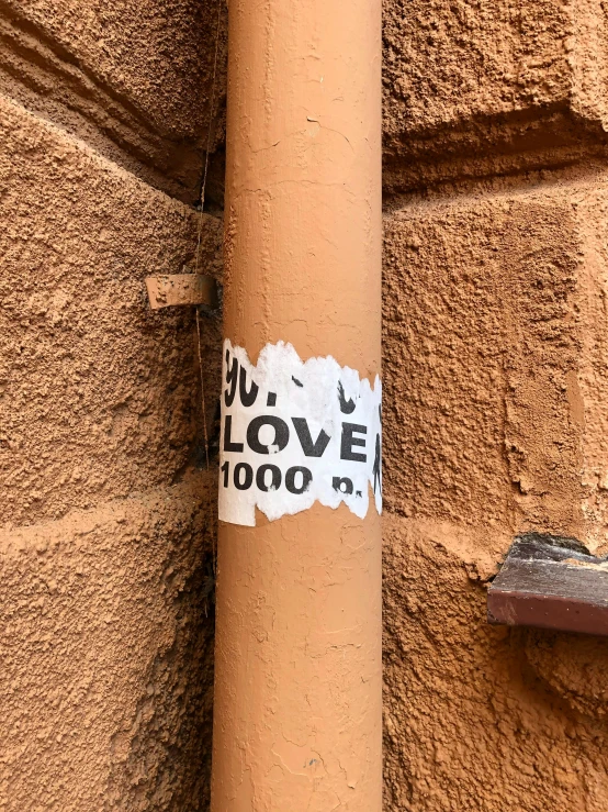 a sticker that is on the side of a building, 1/1000, the new love, ((rust)), 1km tall