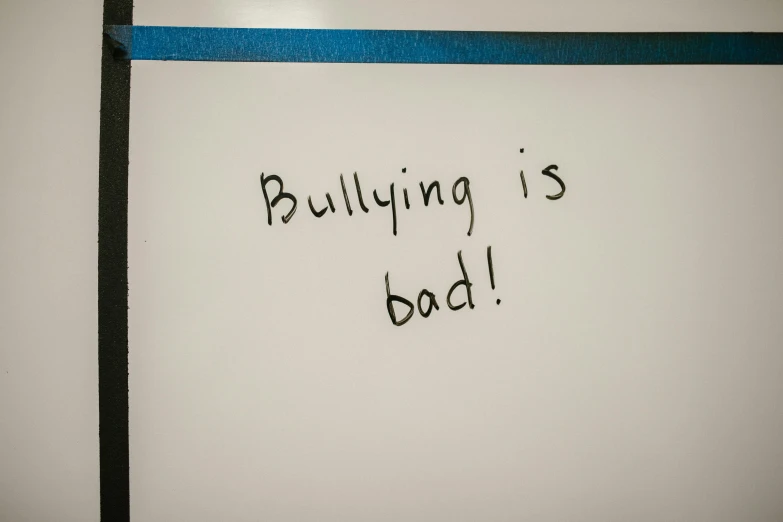 a whiteboard with the words building is bad written on it, bullying, blue, candid photograph, bull