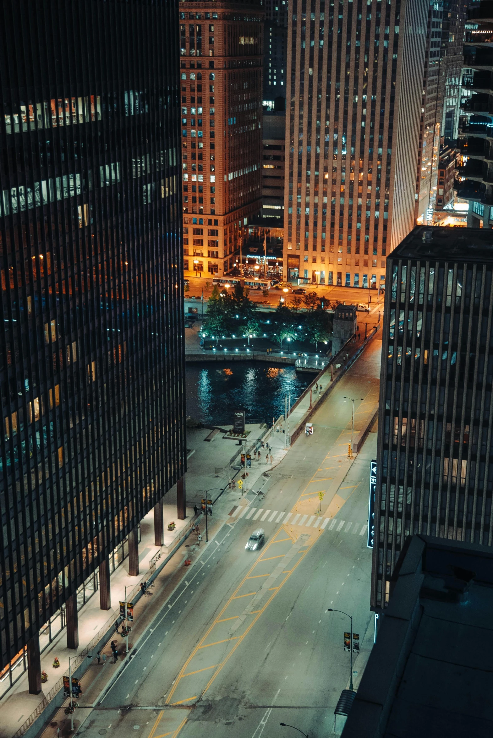 an aerial view of a city at night, by Andrew Domachowski, pexels contest winner, photorealism, modern chicago streets, 2000s photo, mies van der rohe, location [ chicago ( alley ) ]