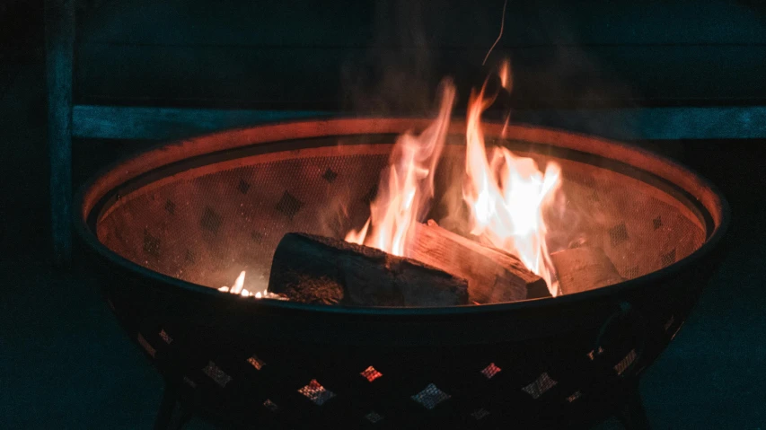 a close up of a fire in a fire pit, pexels contest winner, rim lit, instagram post, videogame still, 33mm photo