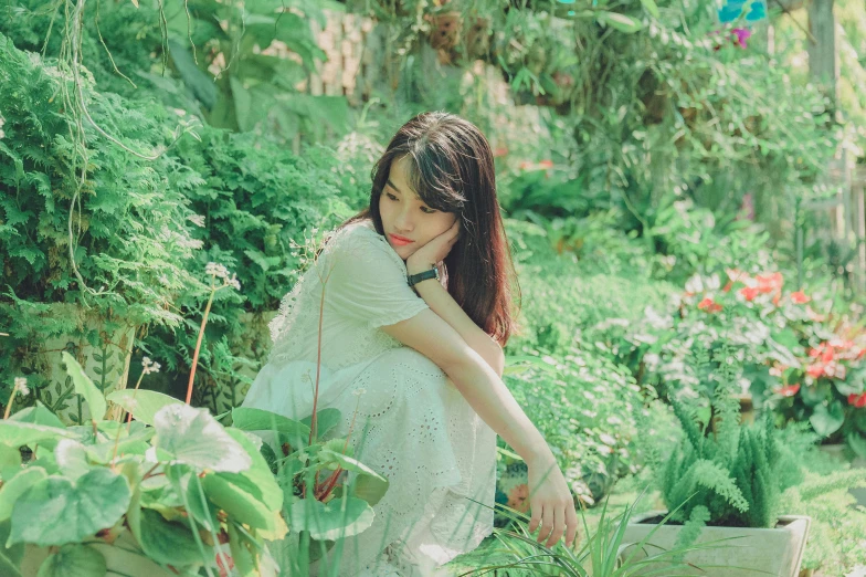 a woman sitting on the ground in a garden, a picture, by Tan Ting-pho, unsplash, realism, bae suzy, lush green, iu, white hue