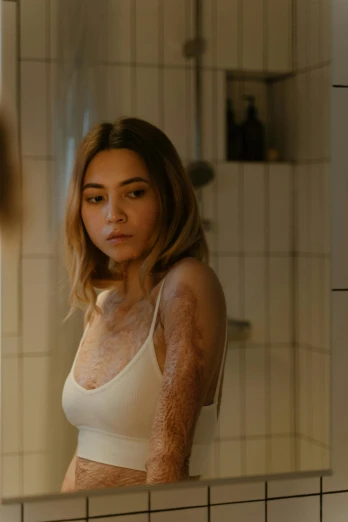 a woman standing in front of a bathroom mirror, inspired by Elsa Bleda, process art, dirt - stained skin, madison beer, scene from live action movie, furr covering her chest