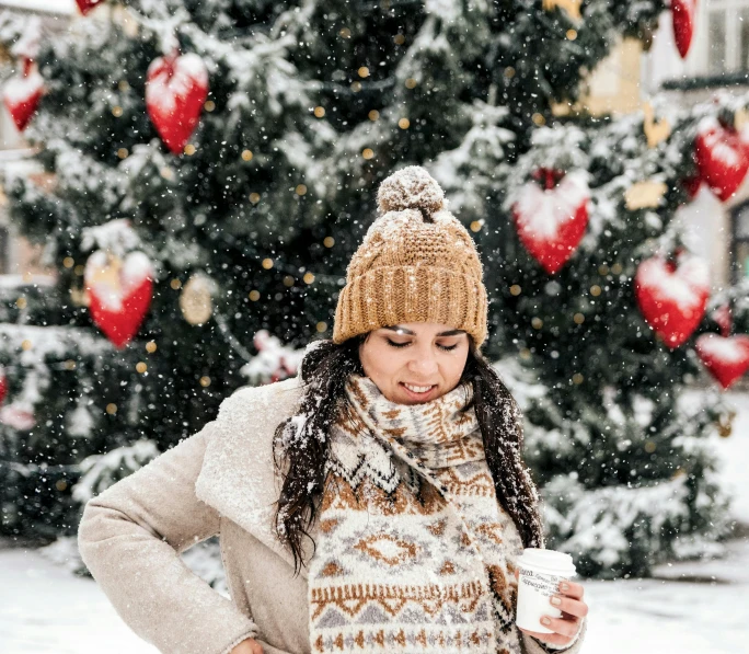 a woman standing in front of a christmas tree, by Julia Pishtar, pexels contest winner, hot cocoa drink, gentle snow, 😭 🤮 💕 🎀, avatar image