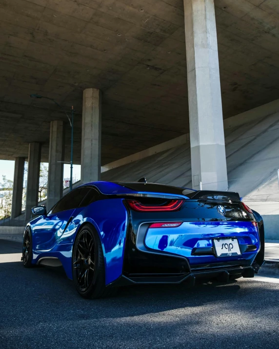 a blue sports car parked under a bridge, inspired by Nōami, unsplash, oil slick colors, bmw i 8, thumbnail, 8k octan photo