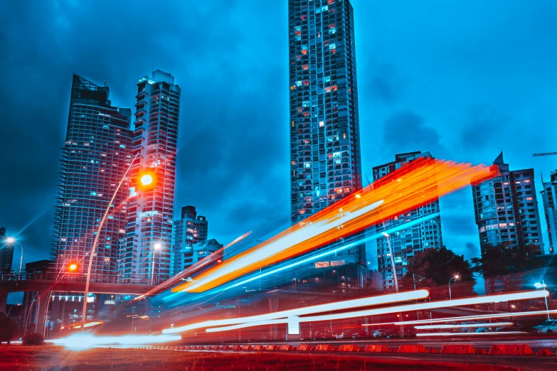 a street filled with lots of traffic next to tall buildings, by Carey Morris, pexels contest winner, visual art, blue and red lighting, high speed motion, thumbnail, enhanced quality