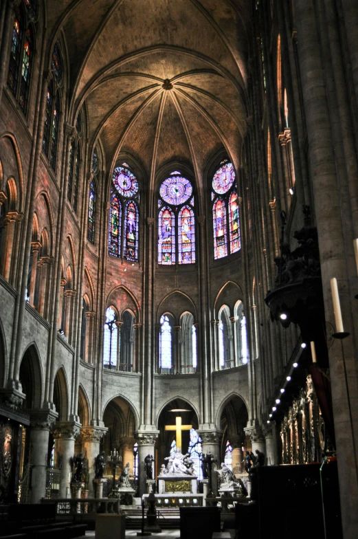 the interior of a cathedral with stained glass windows, inspired by François Joseph Heim, huge support buttresses, color”