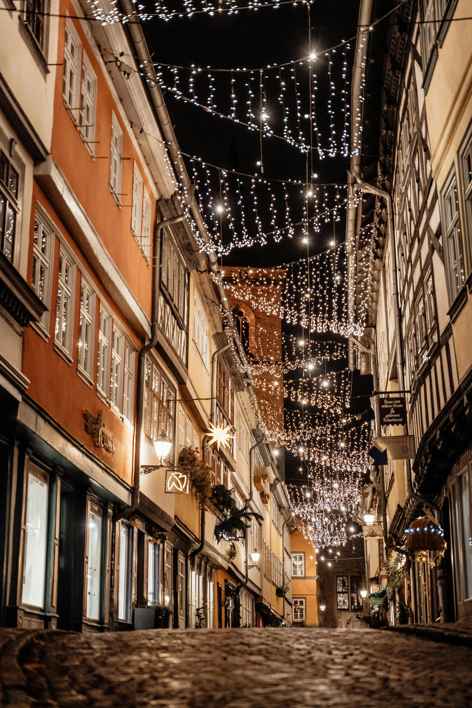 a street filled with lots of lights next to tall buildings, a photo, renaissance, detmold, profile image, decorations, portugal