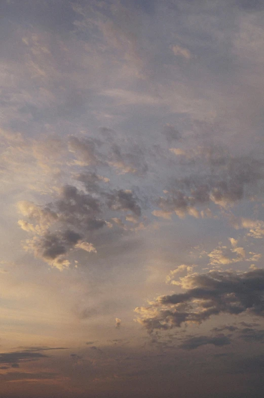 a man flying a kite on top of a sandy beach, a picture, unsplash, romanticism, layered stratocumulus clouds, sunset panorama, grey, ((sunset))