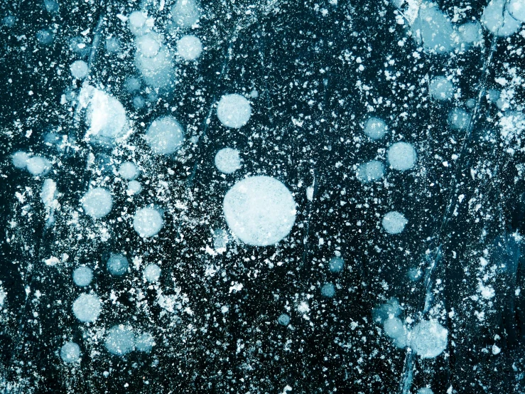 a bunch of bubbles floating in the air, a microscopic photo, inspired by Vija Celmins, space art, still life with snow, ocean pattern and night sky, wet concrete, 2000s photo