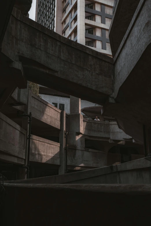 a man riding a skateboard up the side of a ramp, a photo, unsplash contest winner, brutalism, brutalist architecture buildings, it's getting dark, apartment complex made of tubes, looking from slightly below