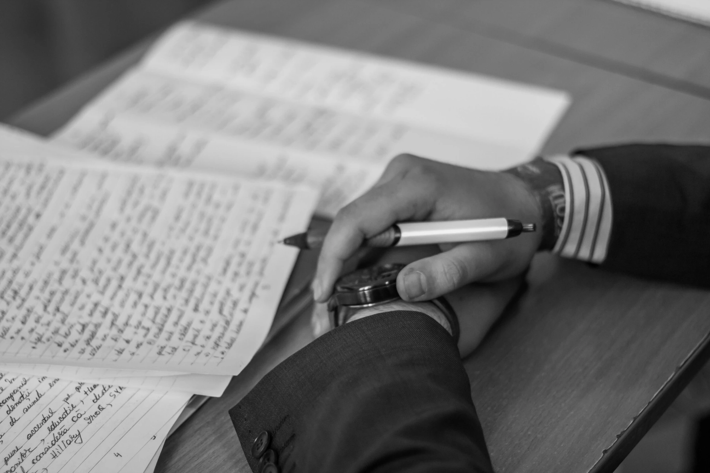 a black and white photo of a person writing on a piece of paper, by Romain brook, high quality upload, fan favorite, notebook, high details photo