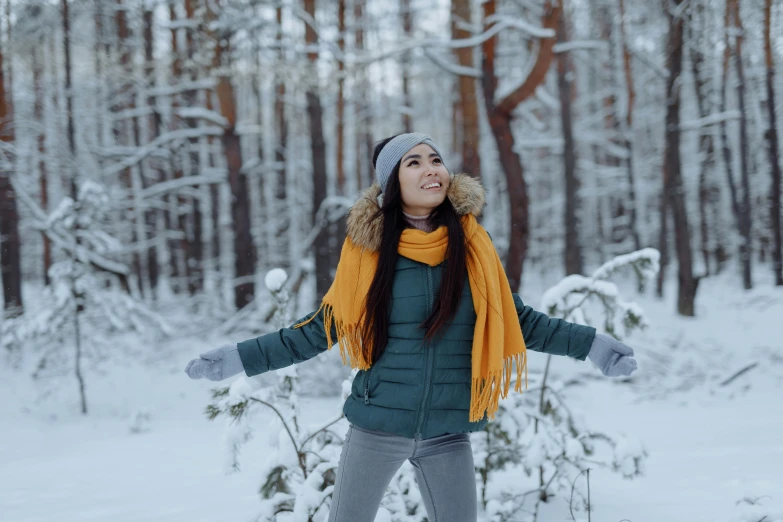 a woman standing in the snow with her arms outstretched, pexels contest winner, enjoying a stroll in the forest, avatar image, wearing casual clothing, attractive photo