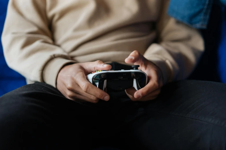 a man holding a video game controller in his hands, unsplash, avatar image