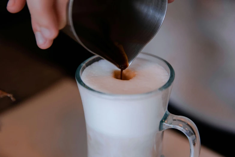 a close up of a person pouring liquid into a cup, by Robbie Trevino, milk and mocha style, avatar image, high quality image, thumbnail