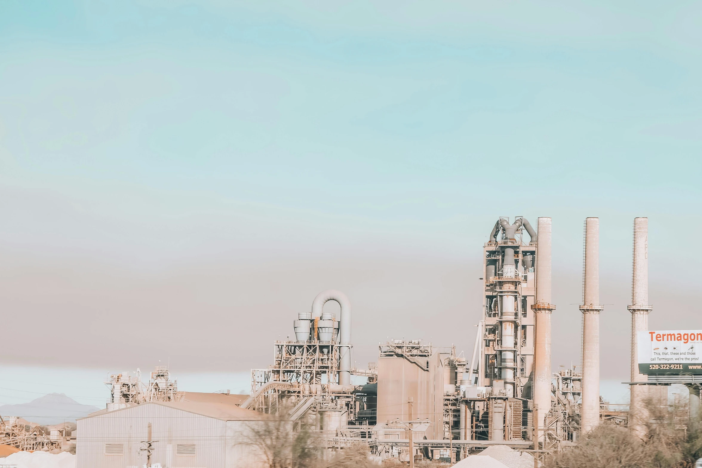 a factory that is sitting in the middle of a field, pexels contest winner, petrol aesthetic, high key detailed, bay area, high quality product image”