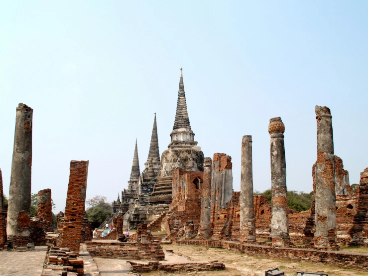 a group of ruins with a clock tower in the background, thai architecture, asymmetrical spires, distant photo, thumbnail