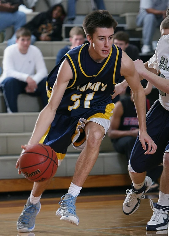 a group of young men playing a game of basketball, lynn skordal, in a medium full shot, danny fox, navy