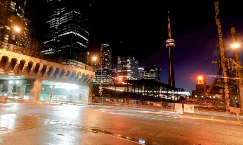 a city street filled with lots of traffic at night, by Carey Morris, pexels contest winner, hurufiyya, cn tower, slide show, streetlights, 1 2 9 7