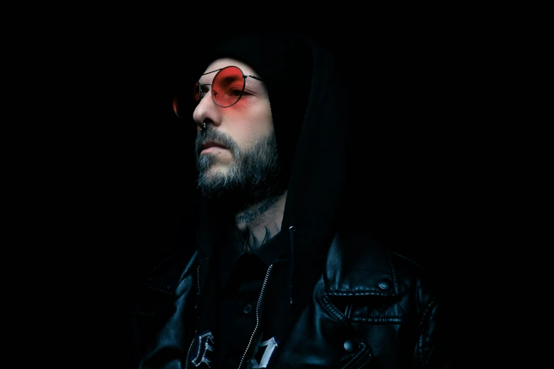a man in a leather jacket and sunglasses, an album cover, inspired by Elsa Bleda, trending on pexels, sots art, rugged man portrait, techwear occultist, lights in the dark, press shot