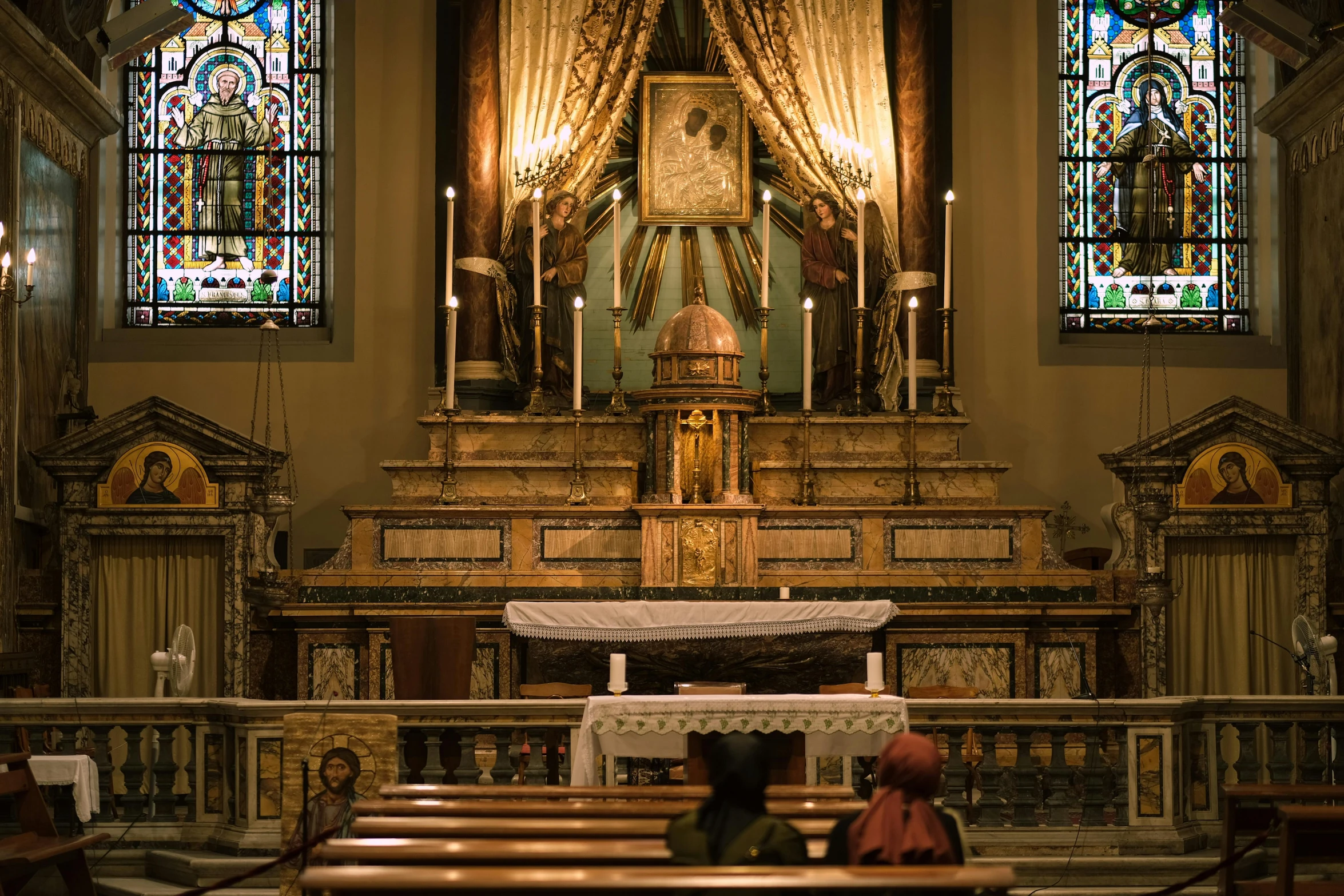 a couple of people that are sitting in a church, unsplash, renaissance, displayed on an altar, brown, melbourne, scientific photo