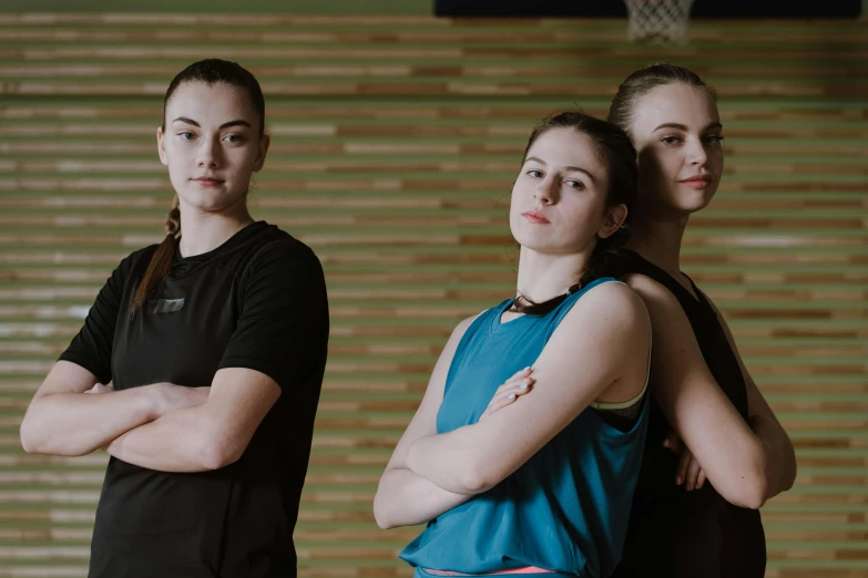 a group of young women standing next to each other, by Emma Andijewska, basketball, profile image, dim dingy gym, commercially ready