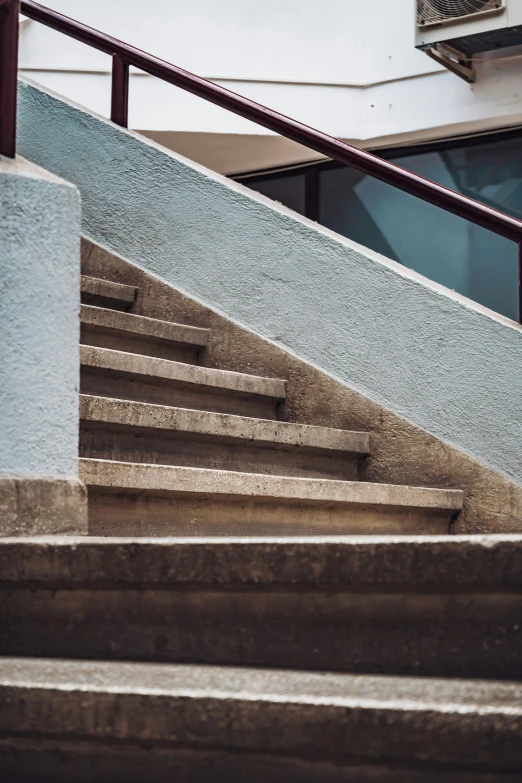 a man riding a skateboard down the side of a flight of stairs, inspired by Elsa Bleda, unsplash, brutalism, abstract detail, concrete ), color photo, made of concrete