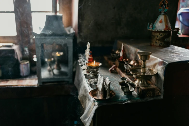 a stove top oven sitting next to a window, a still life, by Daniel Lieske, trending on unsplash, standing in a hindu kovil, magical potions, copper and brass, tea drinking and paper lanterns